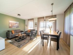 a living room with a table and a couch at Holiday Home in Scherpenisse near Nature Reserve in Westkerke
