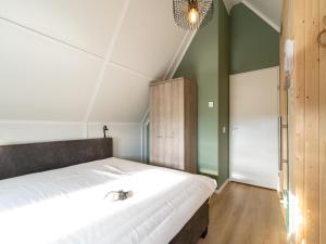 a bedroom with a large bed and green walls at Holiday Home in Scherpenisse near Nature Reserve in Westkerke