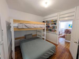 a bedroom with two bunk beds and a book shelf at Sanctuary Retreat in North Avoca