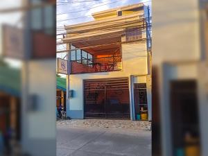 a building with a garage with a balcony on it at Althea Apartelle in Moalboal +9 photos