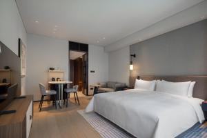 Voodi või voodid majutusasutuse New World Guangzhou Hotel toas