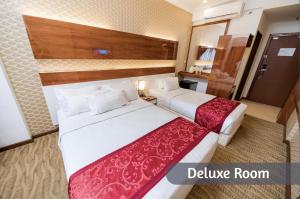 Postel nebo postele na pokoji v ubytování MITC Hotel