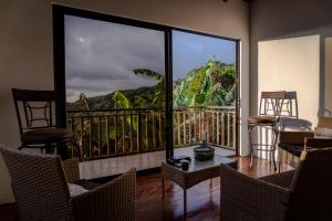 a room with a balcony with a view of a mountain at Casa Curré Monteverde in Monteverde Costa Rica