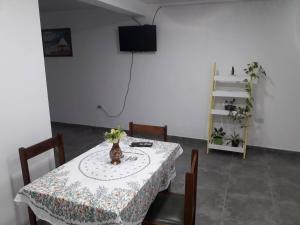 a dining room with a table and chairs and a television at Departamento federación in Federación