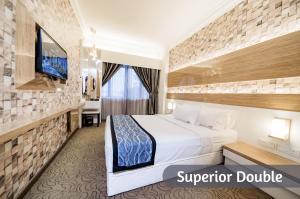 Postel nebo postele na pokoji v ubytování MITC Hotel