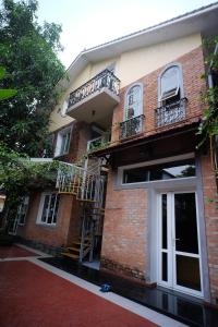 a brick building with a staircase and a balcony at Lagom Home in Hue
