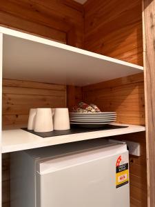 a refrigerator with a plate of food on a shelf at The River Retreat Buchan in Buchan