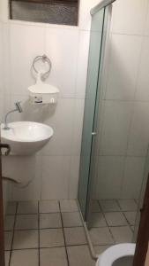 a bathroom with a shower and a sink and a toilet at Apartamento no terreo in Natal