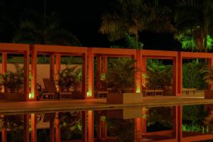 a building with a reflection in the water at night at Hotel Morúa in Yopal