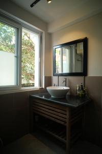 a bathroom with a sink and a mirror on a counter at Lagom Home in Hue