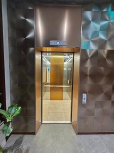 an elevator in a building with a glass door at Miracle Suite house 201 pool villa in Incheon