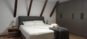 a bedroom with a large bed with white sheets at GM 15 Apartments in Sibiu