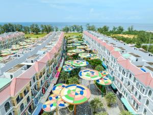 an overhead view of a row of hotels with umbrellas at 222 ROSÉ Hotel in Phú Quốc