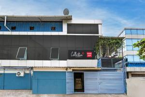 a building with blue doors in front of it at Collection O Dsp Hotels in Ghansoli