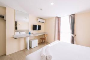 a hotel room with a bed and a desk at One Budget Chiangrai Phahonyothin in Ban Pa Kluai