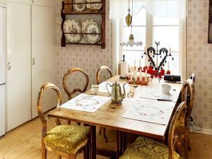 a dining room with a wooden table and chairs at Holiday home SILJANSNÄS in Siljansnäs