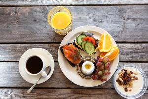 Hotelli Olla في Somero: صحن من الطعام مع الفاكهة وكوب من القهوة