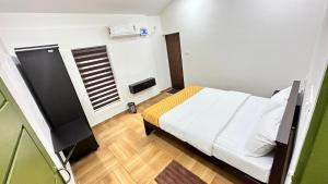 A bed or beds in a room at Better Inn AC Villa Kovalam