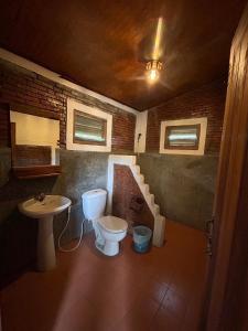 a bathroom with a toilet and a sink at Pai Love & Baan Chonphao Resort in Pai