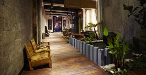 a hallway with chairs and tables in a store at 1825 Gallery Hotel in Melaka