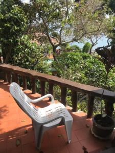 a white chair sitting next to a wooden bench at Suncliff Resort in Haad Rin