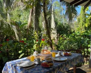 a table with food on it in a garden at Sun & Tree HomeStay (With Green Nature View) in Mirissa