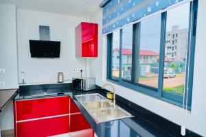 a kitchen with a sink and a large window at The Pearls in East Legon
