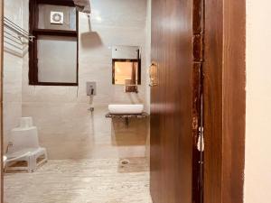 a bathroom with a sink and a mirror at The White House Haridwar in Haridwār