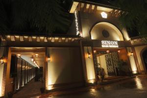 a building with a sign for a hotel at night at Sinon Baga Retreat in Baga
