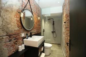 a bathroom with a white sink and a brick wall at Beijing MutianyuGreat Wall Let'sgo coffee&homesty in Huairou
