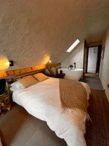 a bedroom with a large bed and a bath tub at Shard Boutique Hotel-adult only in Braşov