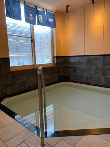 an empty swimming pool in a room with at Plum House Otaru in Otaru