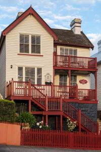 a house with a large deck on the side of it at Mersey River Cottage ( cir 1888) Central location with Amazing Ocean and Habour Views. in Devonport