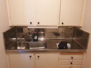 a kitchen counter top with a sink and a sink at Central hel lägenhet. Nära till allt. in Umeå