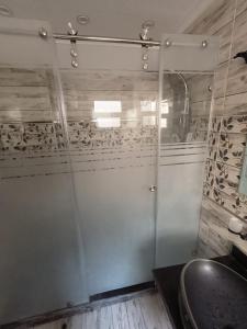 a bathroom with a glass door with a sink at wow super lux apartment near to Nile شقة سوبر لوكس جديدة جامعة الدول العربية المهندسين in Cairo