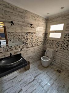 a bathroom with a tub and a toilet and a sink at wow super lux apartment near to Nile شقة سوبر لوكس جديدة جامعة الدول العربية المهندسين in Cairo