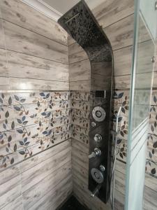 a shower in a bathroom with wooden walls at wow super lux apartment near to Nile شقة سوبر لوكس جديدة جامعة الدول العربية المهندسين in Cairo