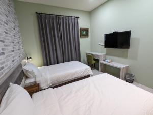 A bed or beds in a room at Ramble Travel Homestay