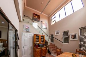a living room with a staircase and a skylight at Guesthouse De Tijger Lodge in Parow