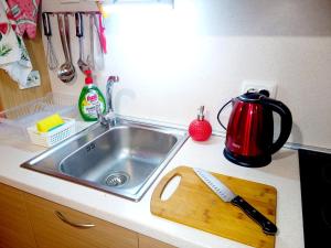 um lavatório de cozinha com uma tábua de cortar e uma chaleira para preparar chá em "Maria Luisa" - Top center apartment em Sófia