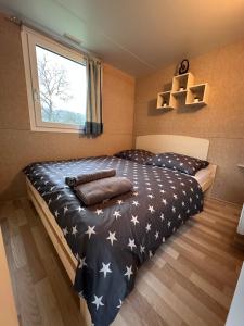 a bedroom with a bed with stars on it at Ranch Houses in Loučná nad Desnou