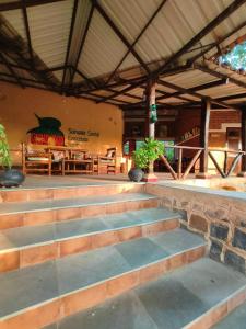 a set of stairs in a building with a table at Surwahi Social Ecoestate Kanha in Kānha