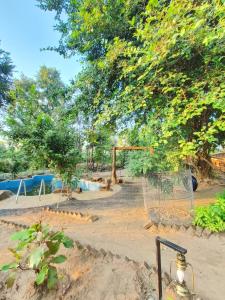 una red de voleibol frente a un parque infantil en Surwahi Social Ecoestate Kanha en Kānha