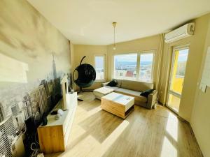 a living room with a couch and a tv at Sunrise Smart Home in Varna City