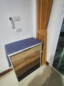 a small bed in a room next to a window at AA Apartment in Koh Samui 