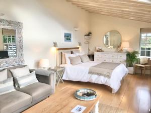a large bedroom with a bed and a couch at Coastal Chic waterfront studio in Kinsale