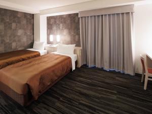 a hotel room with two beds and a window at J - HOTEL RINKU - Vacation STAY 42902v in Tokoname