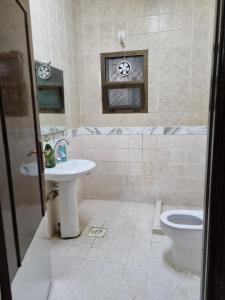 a bathroom with a sink and a toilet at Budget Hostel Rooms in Al Ain