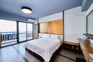 Voodi või voodid majutusasutuse Xinghaiwan B&B toas