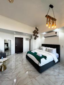 a bedroom with a large bed and a living room at Red Sea Studio Partial Sea View استديو بحر الأحمر اطلالة جزئية in Jeddah